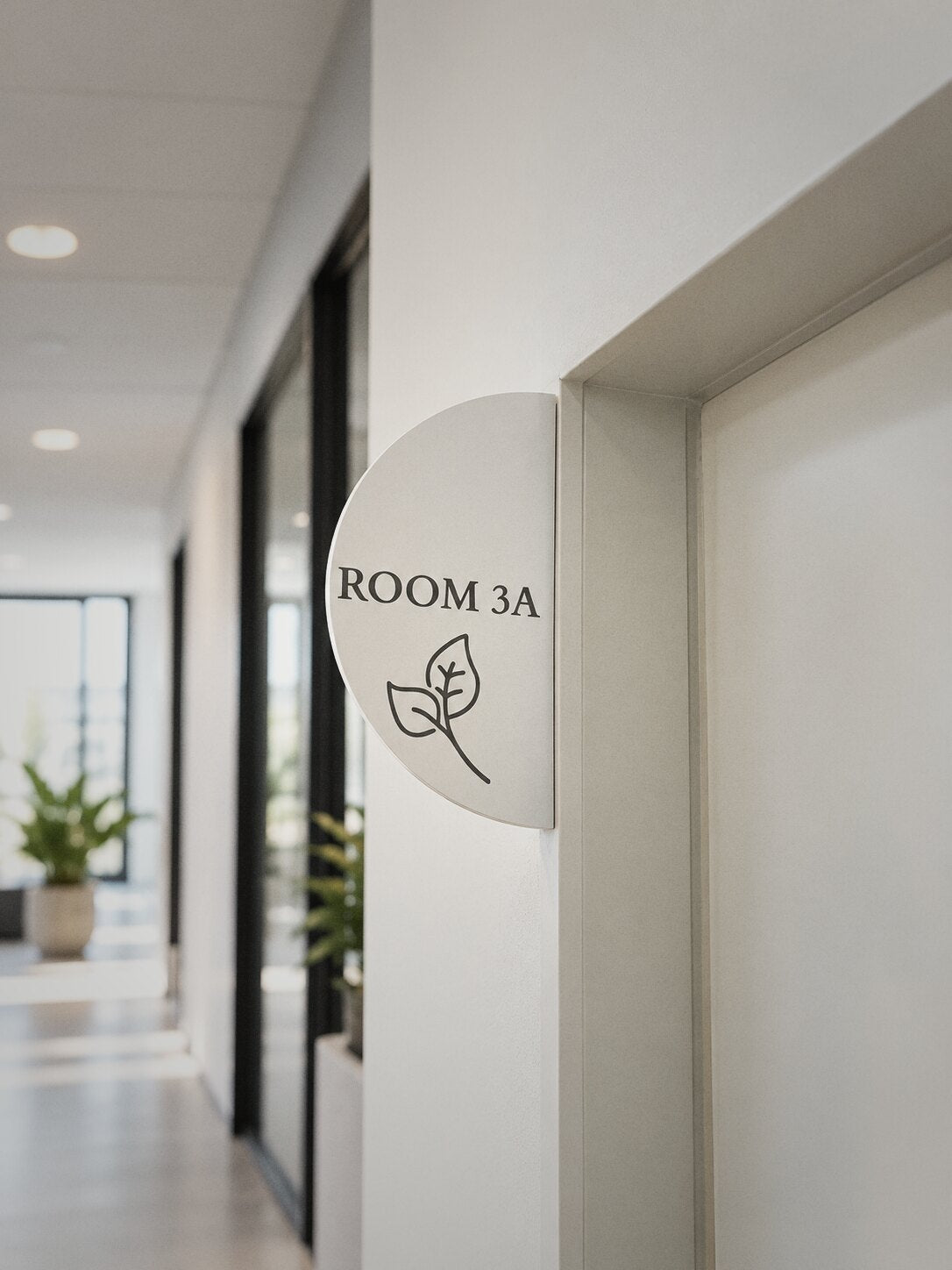 White projecting door sign reading ROOM 3A in an office corridor